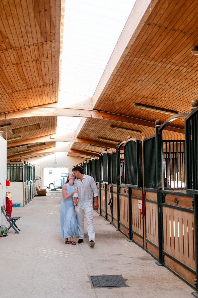 Couple celebrating their surprise proposal in the stables where the groom and sylvia calmet organized everything