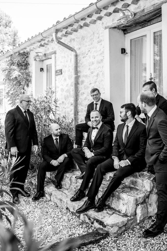 Black and white picture of the groom getting ready with his family