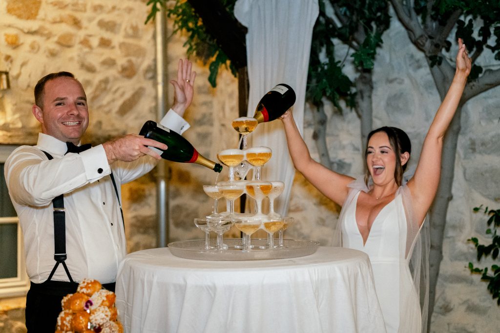 Couple from the us celebrating with champagne at la devèze, south of france, during their wedding