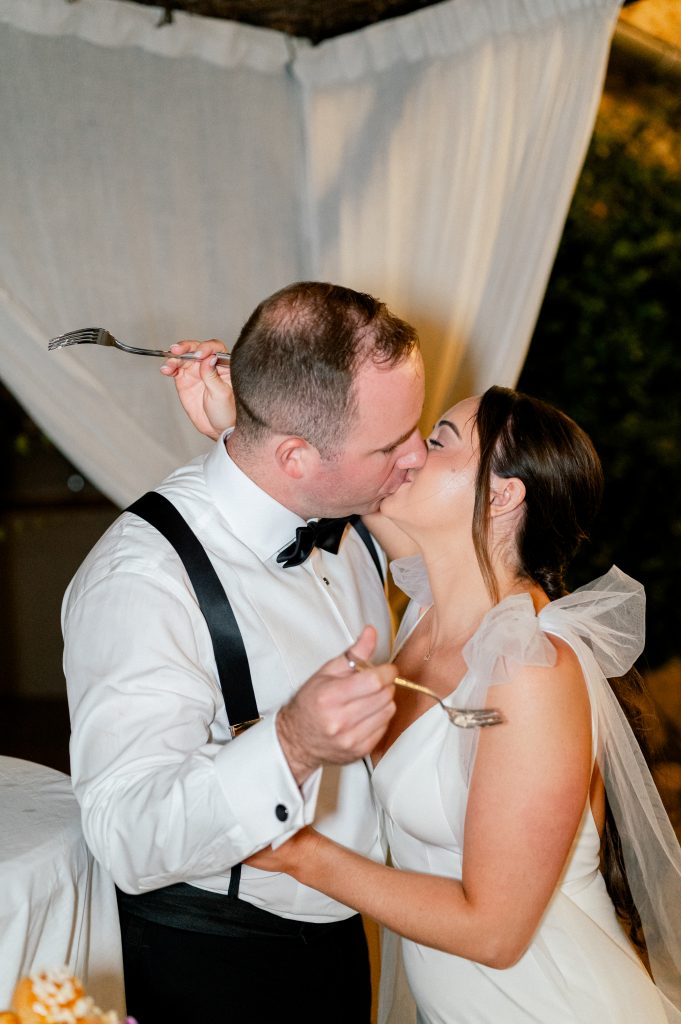 American couple eating cake during their dinner party at la deveze for their destination wedding in the south of france